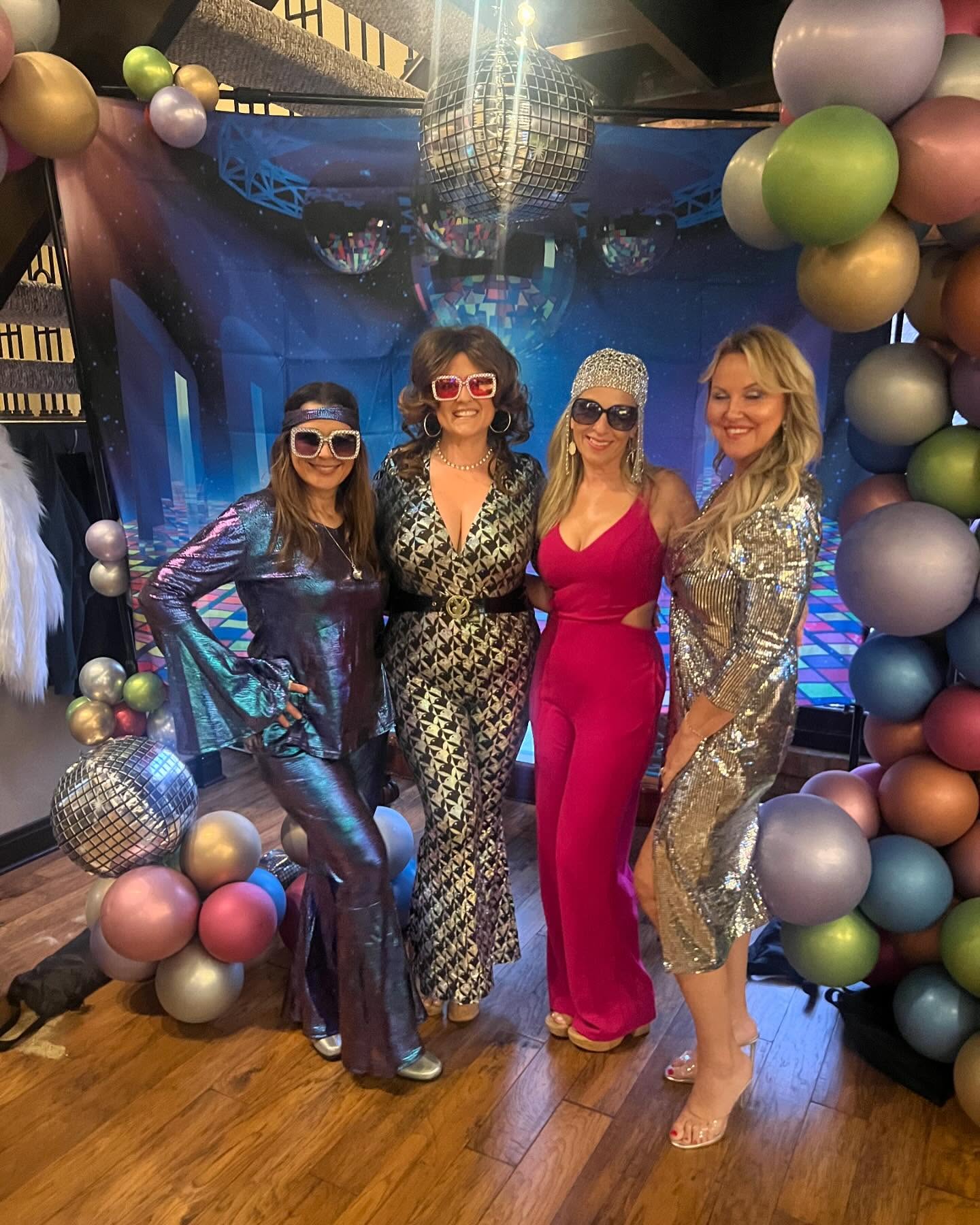 Guests dressed in colorful disco clothing